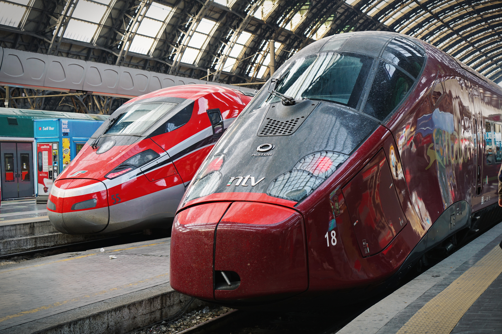 Red High speed train in Central railway station. Milan, Italy - March 2022